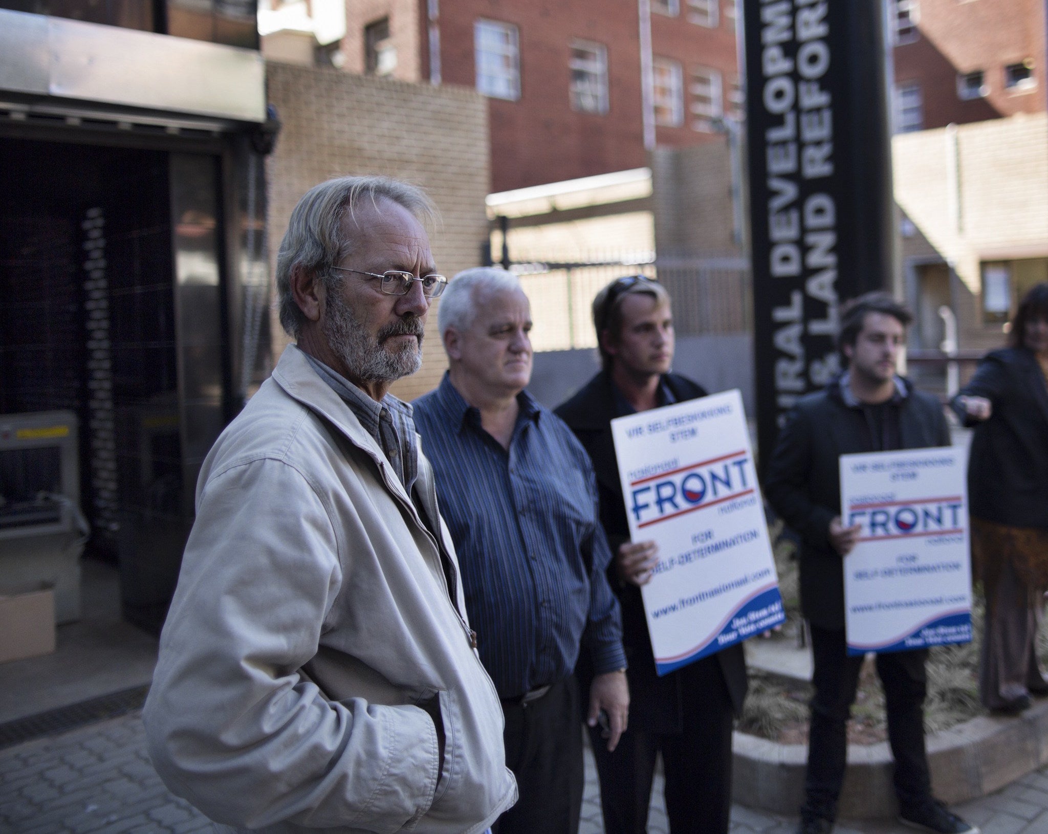 Hannes Engelbrecht (L) leader of the Front National party, speaks to the media on April 24, 2014 as he lodges a land claim on behalf of the old Boer Republics in Pretoria