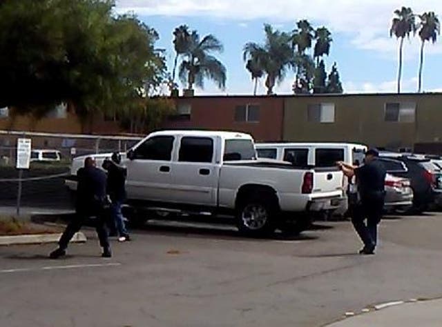 Police say the victim was pointing an object at officers in a 'shooting stance' when he was shot, and released this still image from video footage of the incident