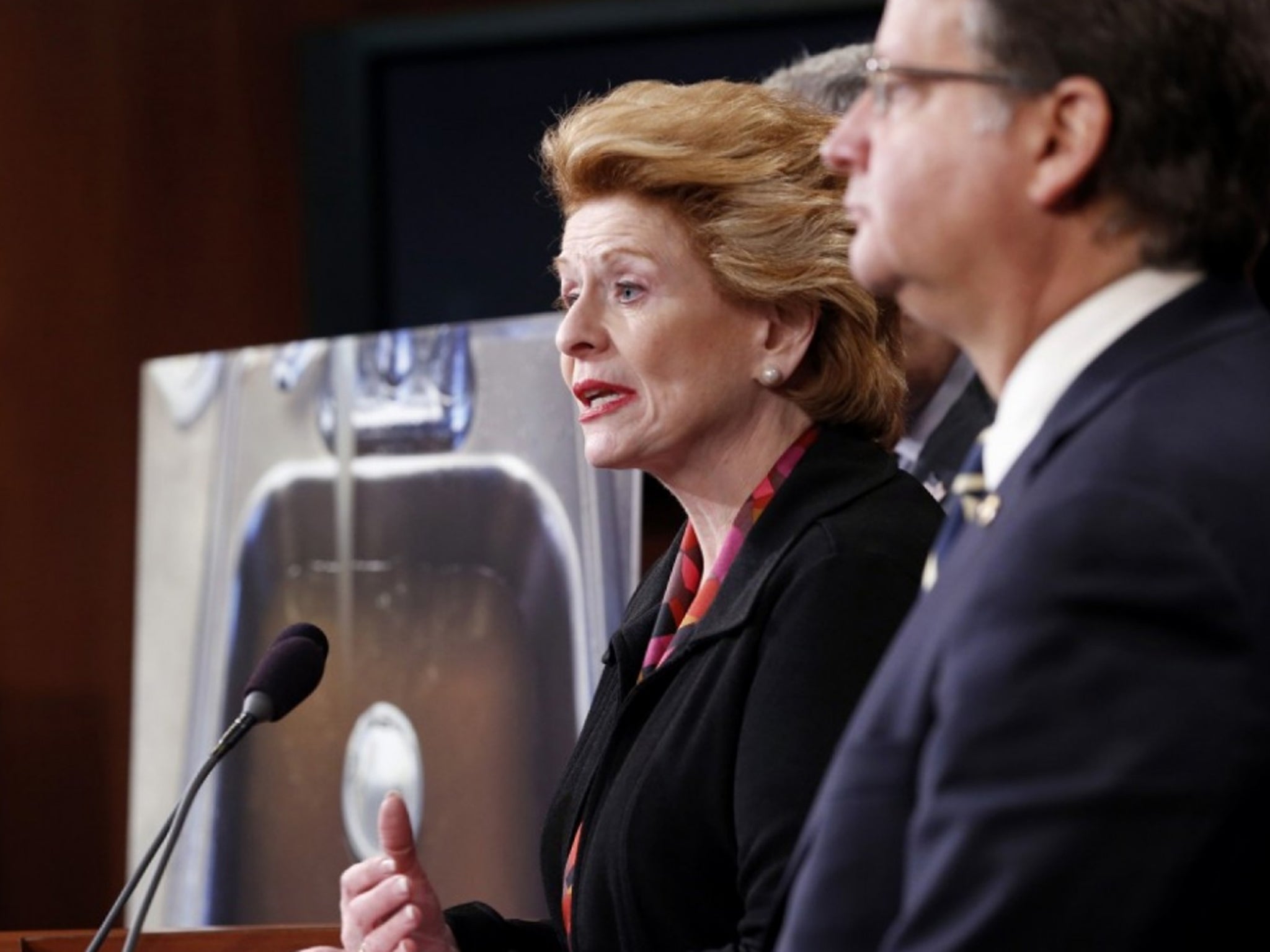 Sen. Debbie Stabenow, D-Mich., left, accompanied by Sen. Gary Peters, D-Mich., and others discusses proposed legislation to help Flint, Mich. with their current water crisis, during a news conference, Thursday, Jan. 28, 2016, on Capitol Hill in Washington
