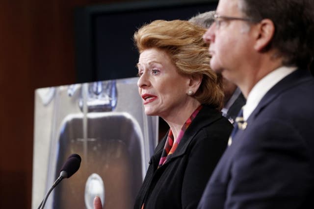 Sen. Debbie Stabenow, D-Mich., left, accompanied by Sen. Gary Peters, D-Mich., and others discusses proposed legislation to help Flint, Mich. with their current water crisis, during a news conference, Thursday, Jan. 28, 2016, on Capitol Hill in Washington
