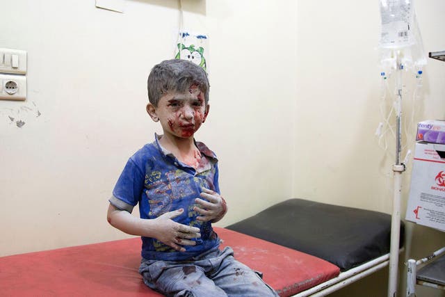 A Syrian boy awaits treatment at a make-shift hospital following air strikes on rebel-held eastern areas of Aleppo on 24 September, 2016