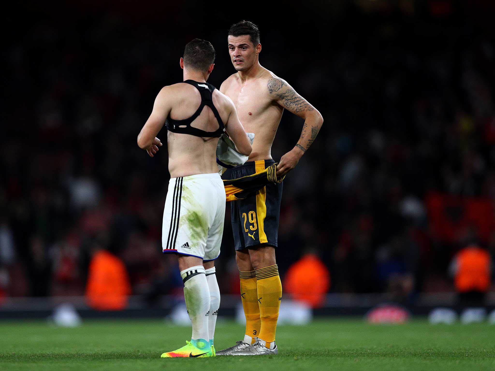 The Xhaka brothers speak among themselves at full-time
