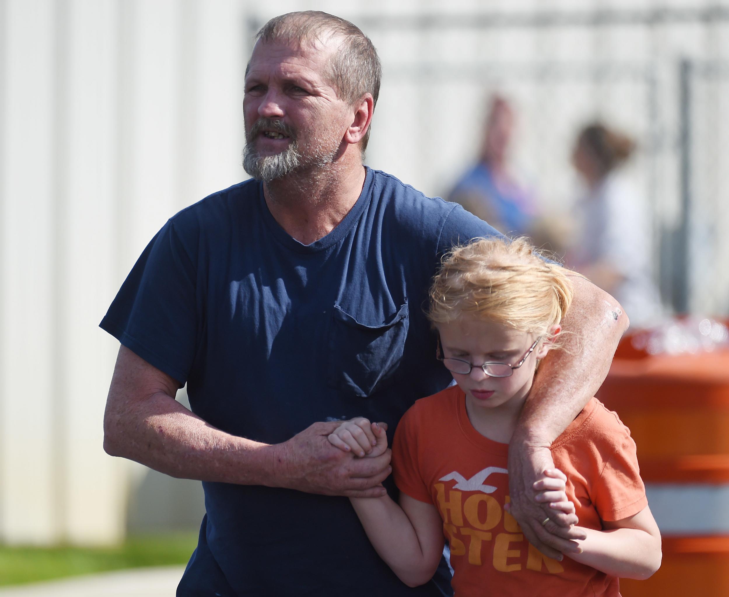 Joey Taylor walks with his daughter Josie Taylor after picking her up at Oakdale Baptist Church on Wednesday