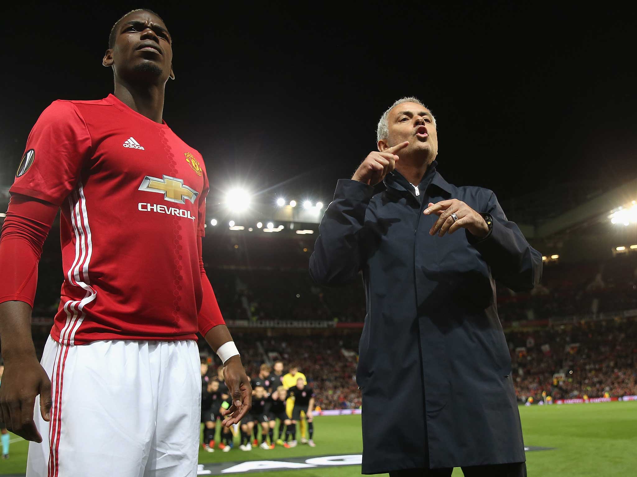 Jose Mourinho barks at his coaching staff as Paul Pogba watches on