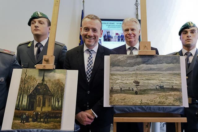 Alex Rueger (C), director of Amsterdam's Van Gogh Museum, stands next to the two recovered paintings