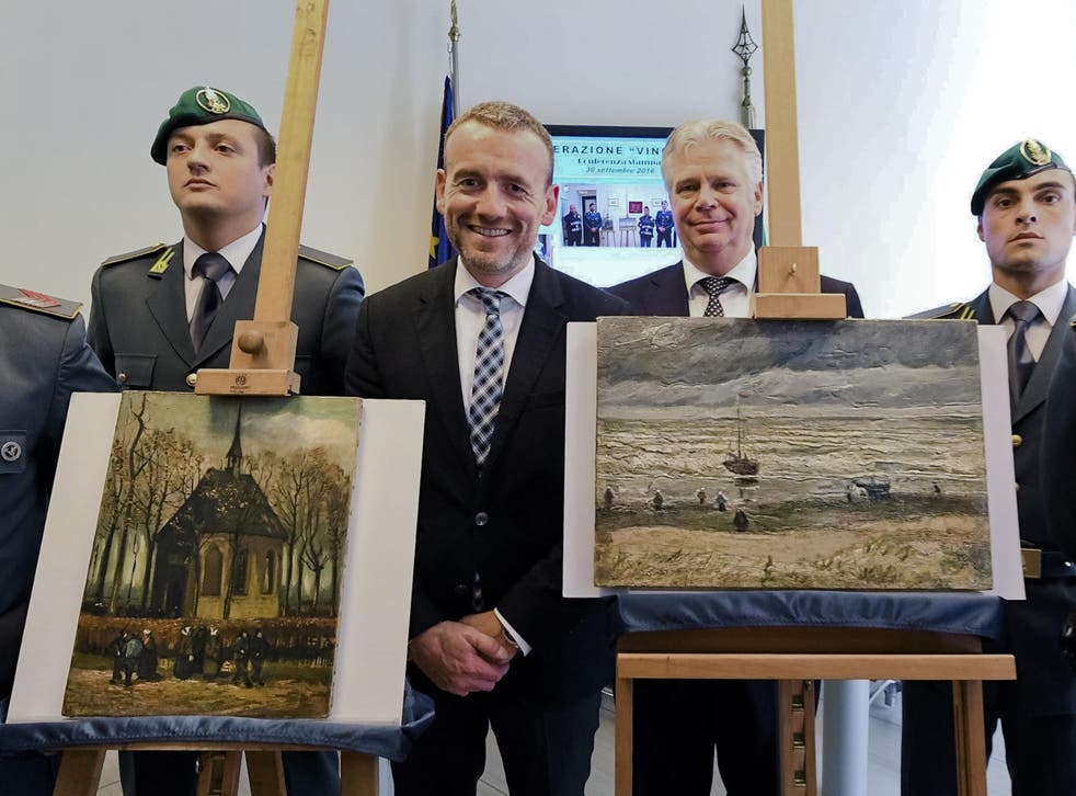 Alex Rueger (C), director of Amsterdam's Van Gogh Museum, stands next to the two recovered paintings