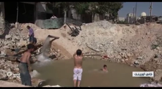 Syria conflict: as war rages, children in Aleppo play in pools left by bomb craters