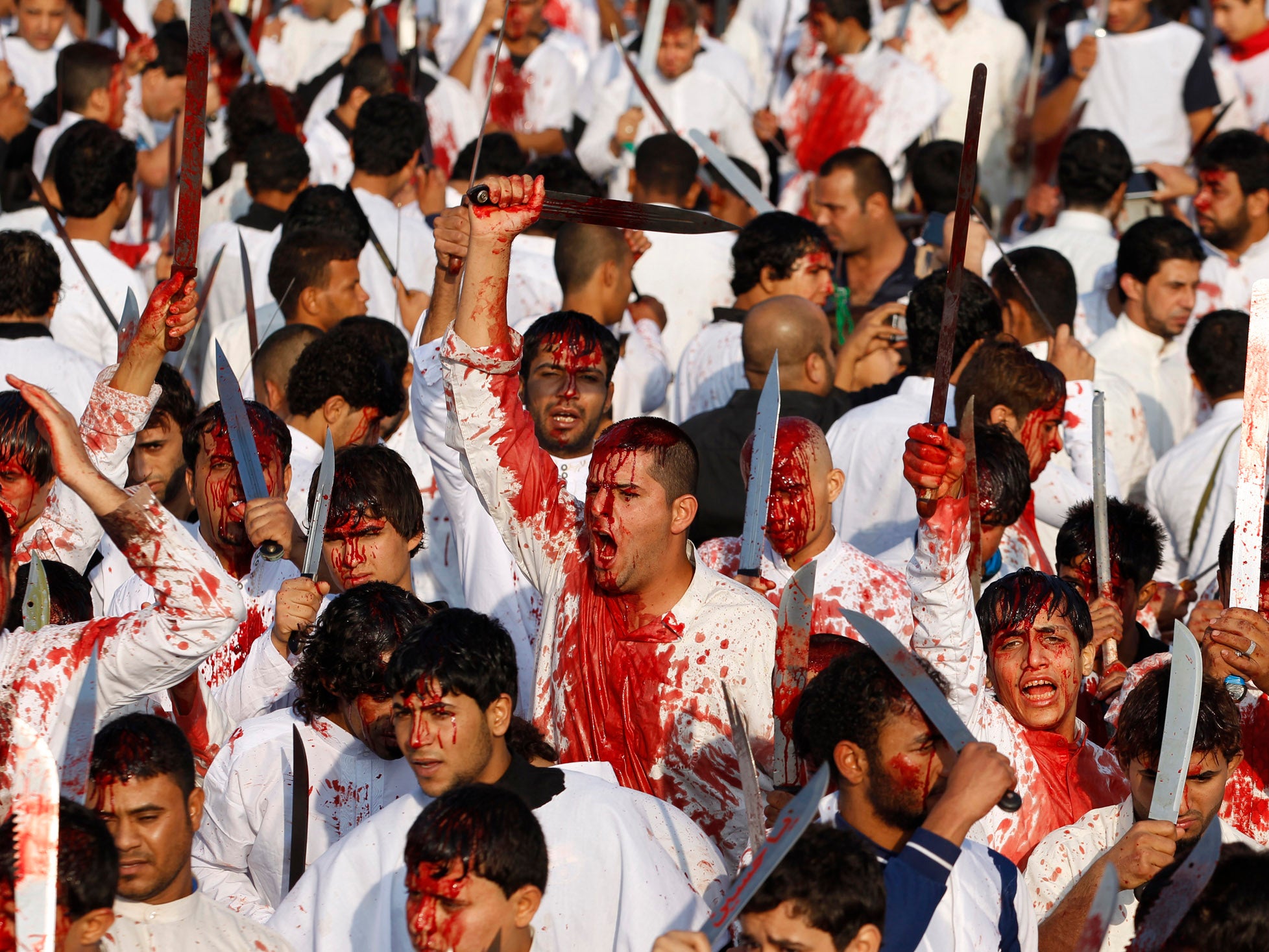 Iraqi Shi’ite Muslims bleed after hitting their foreheads with swords and beating themselves during the religious festival of Ashura in Baghdad