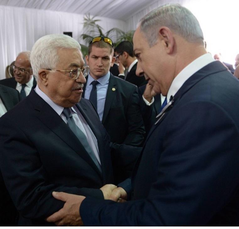 In this handout photo by the Israel Government Press Office (GPO), Israeli Prime Minister Benjamin Netanyahu shakes hands with Palestinian Authority President Mahmoud Abbas