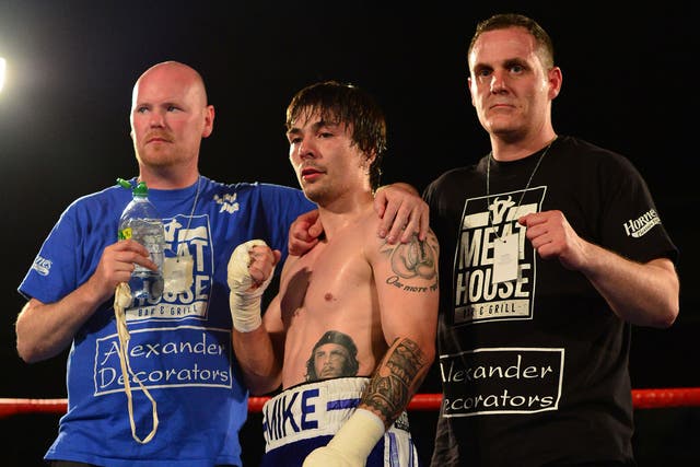 Mike Towell of Dundee celebrates his win over Danny Little of Driffield with his management team during a Welterweight match up at Glasgow's Bellahouston Leisure Centre on May 23, 2015 in Glasgow