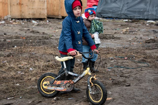 Refugee children playing in the Calais camp which Francois Hollande has vowed to close by the end of the year
