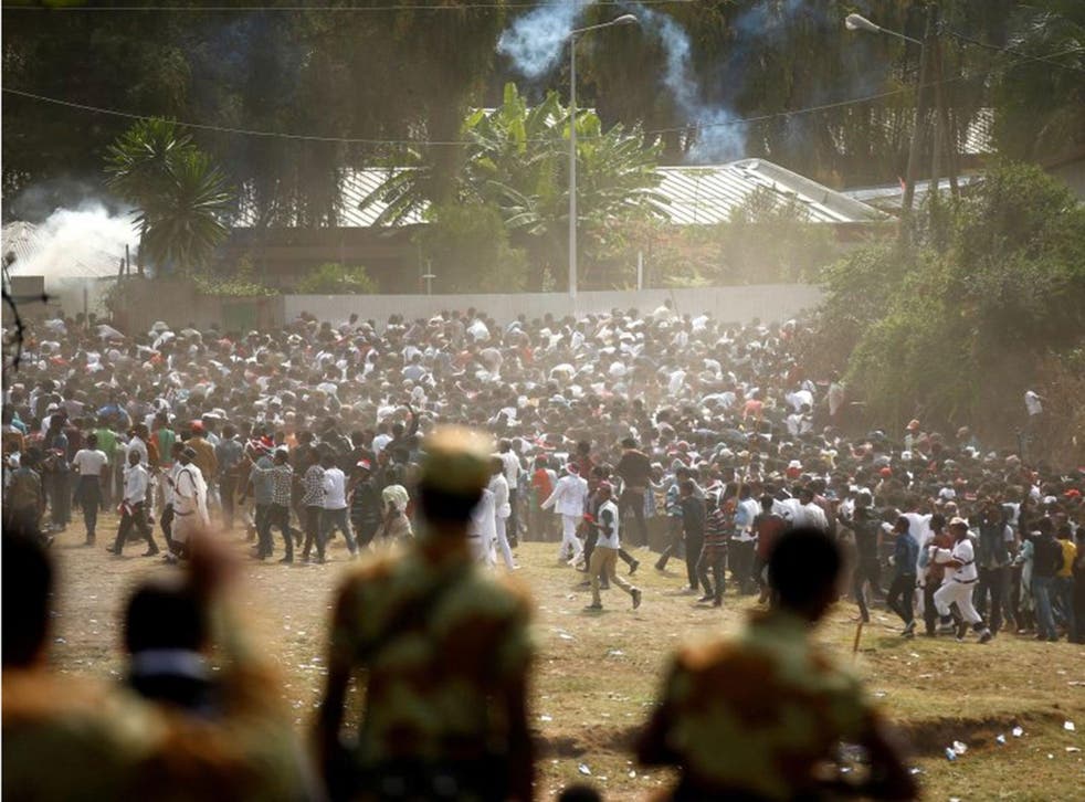 Protestors run from tear gas launched by security personnel during the Irecha, the thanks giving festival of the Oromo people in Bishoftu town of Oromia region, Ethiopia, 2 October, 2016