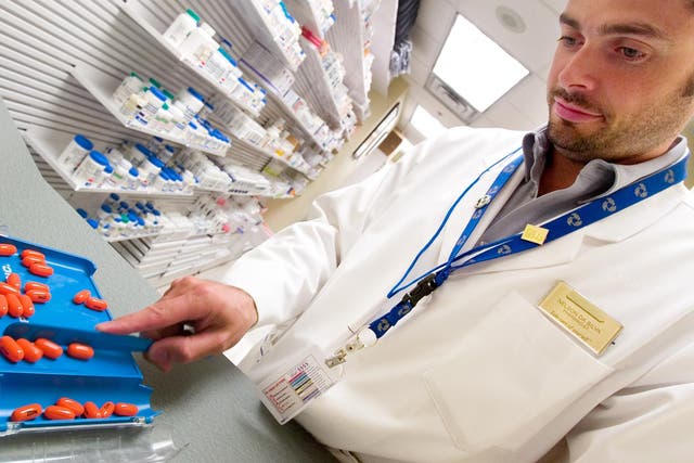 A pharmacist dispenses HIV drugs