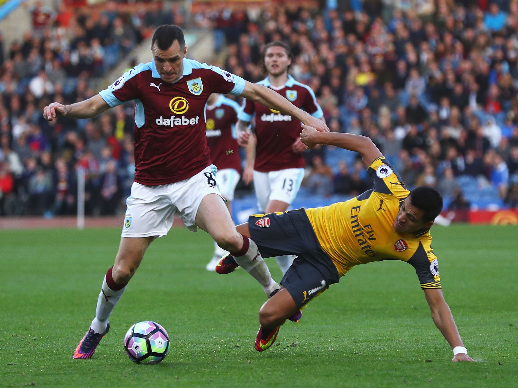 Dean Marney and Alexis Sanchez battle for the ball