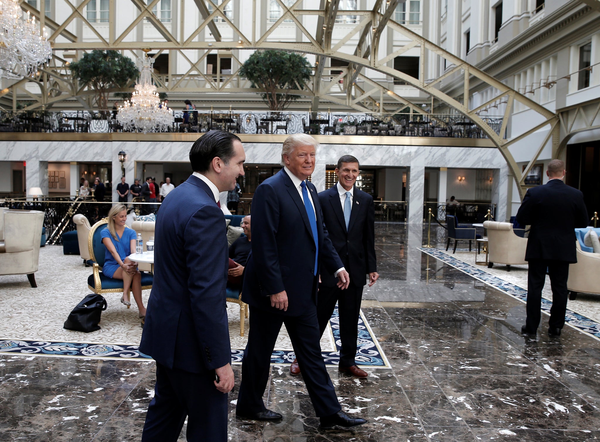 Republican presidential nominee Donald Trump walks through the atrium of his new Trump International Hotel in Washington, D.C