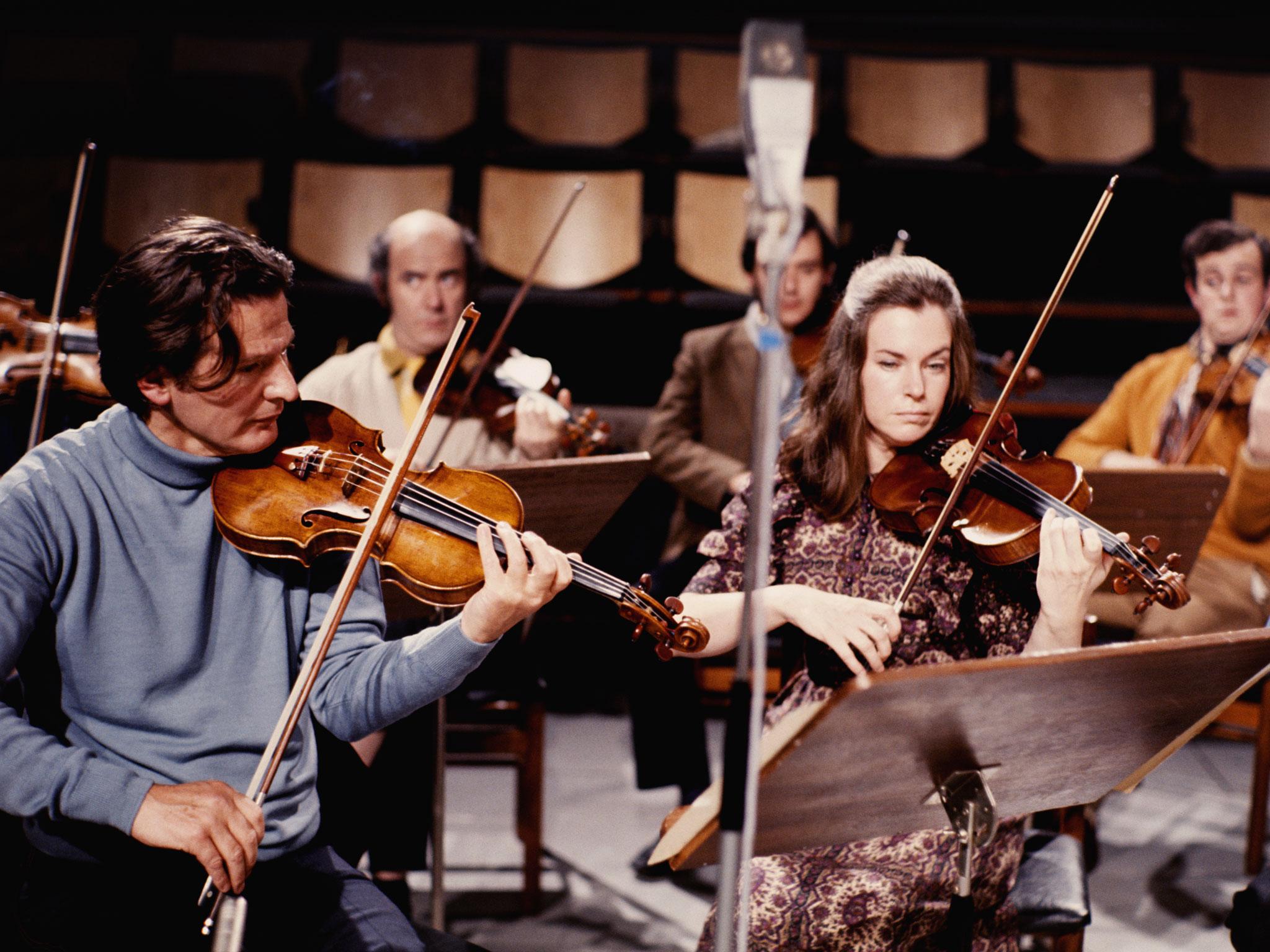 English conductor and violinist Neville Marriner (left) playing with an ensemble in 1965.