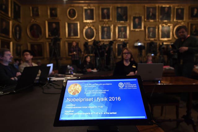 Journalists wait for the beginning of a press conference to announce the winner of the 2016 Nobel Prize in Physics at the Royal Swedish Academy of Sciences in Stockholm