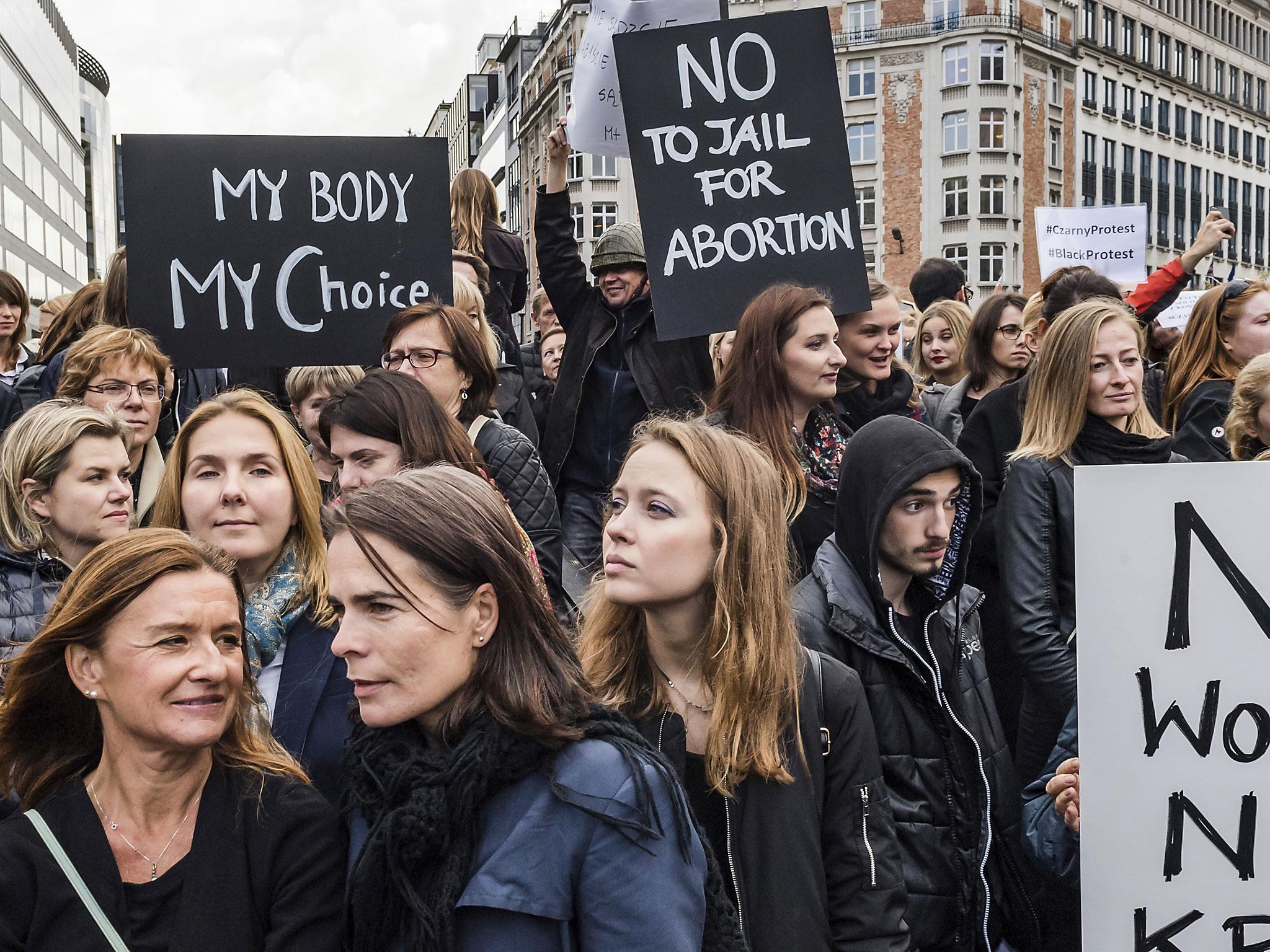 Polish women protest against a legislative proposal for a total ban on abortion in Poland, during a demonstration near EU headquarters in Brussels