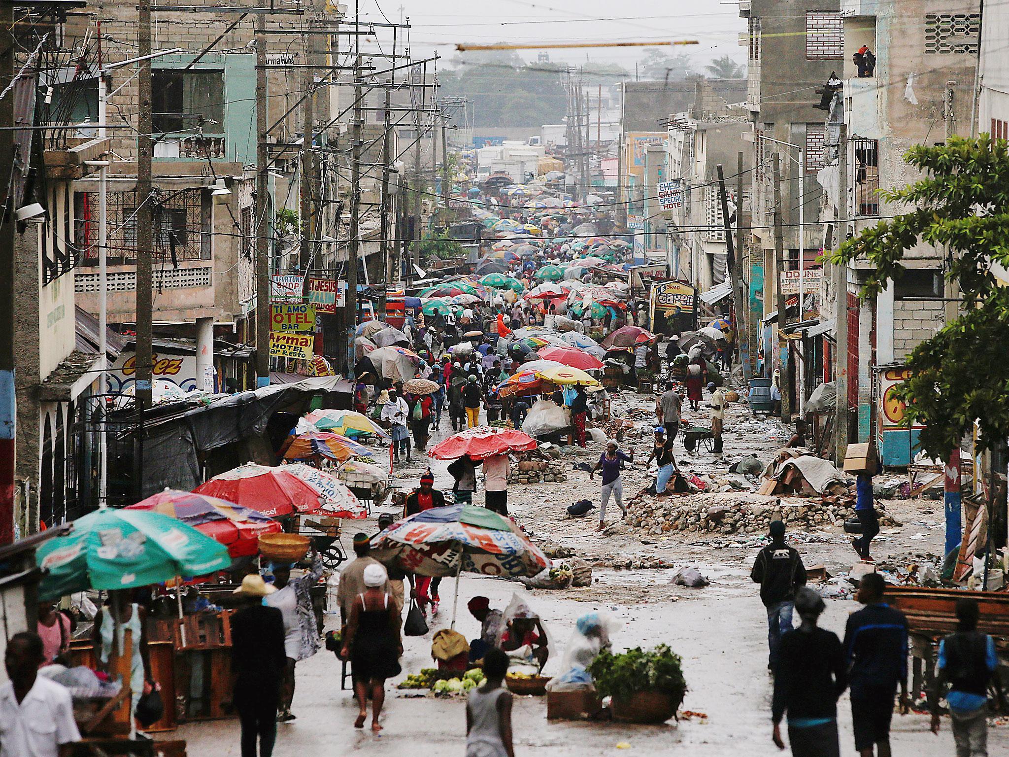 Vendors sell their goods on the street while Hurricane Matthew approaches in Port-au-Prince, Haiti