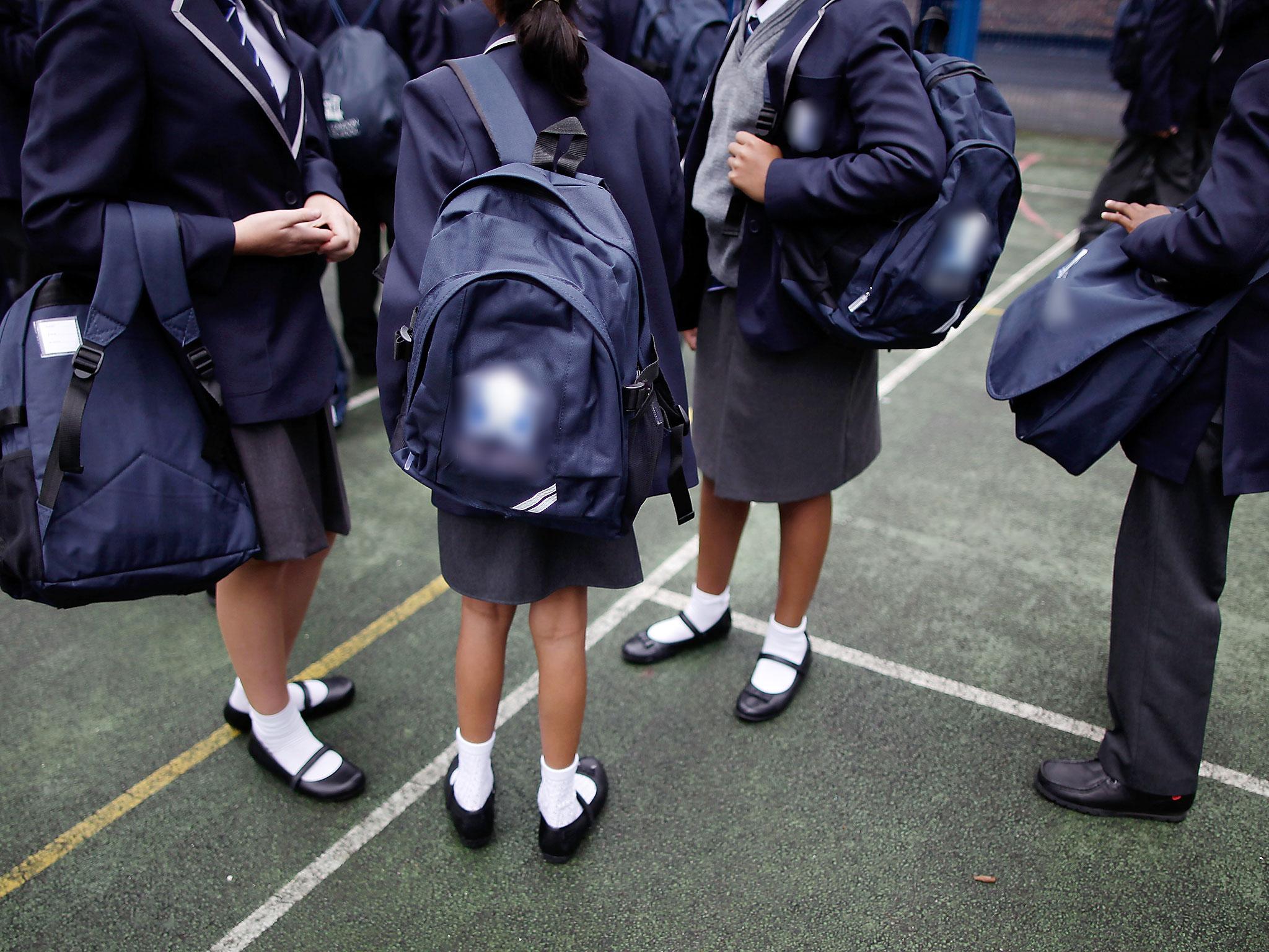 School pupils assemble in a playground