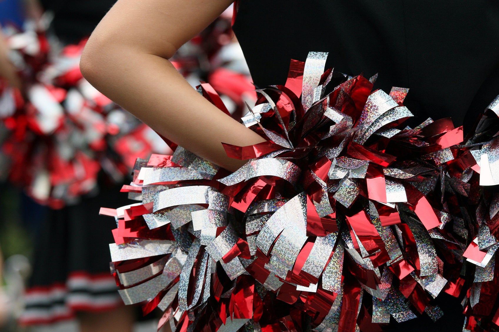 Woman becomes first NFL cheerleader to take a knee during national