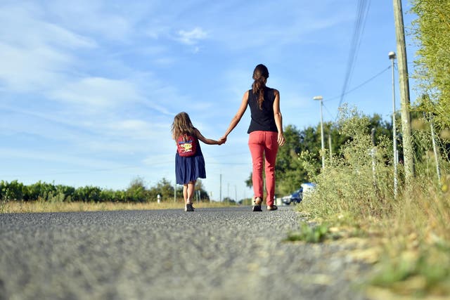 A child goes to school with her mother on September in France