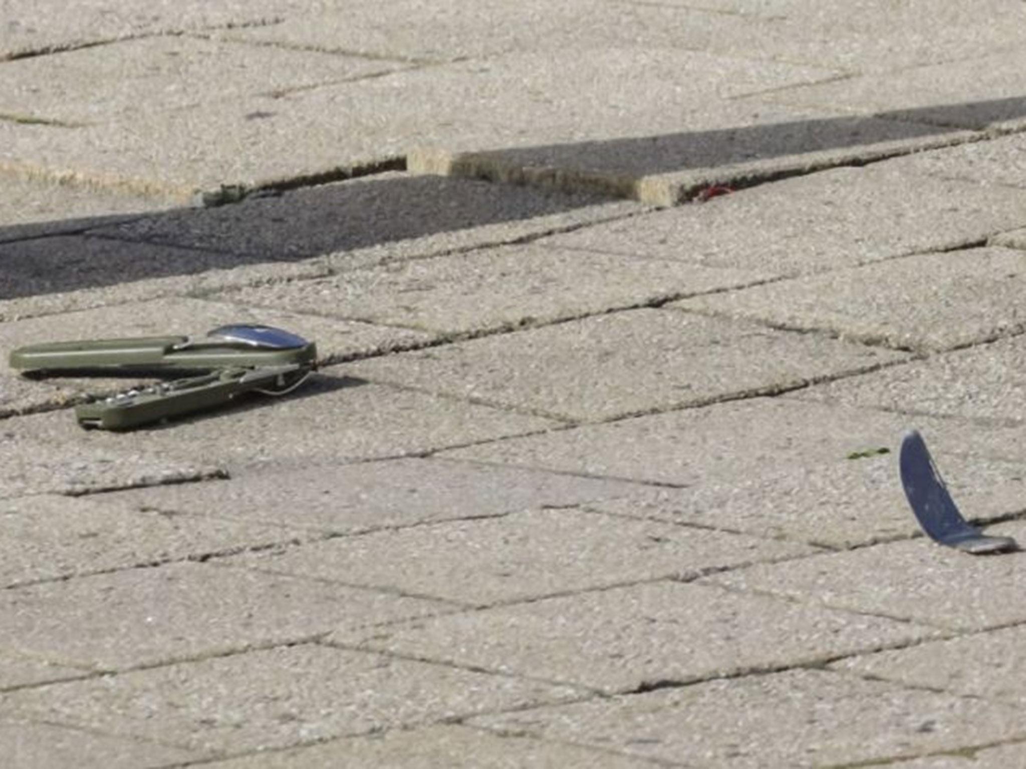 A knife lies on the ground at the scene where an unidentified man stabbed two police officers, in the Schaerbeek neighborhood in Brussels, Wednesday, 5 October, 2016