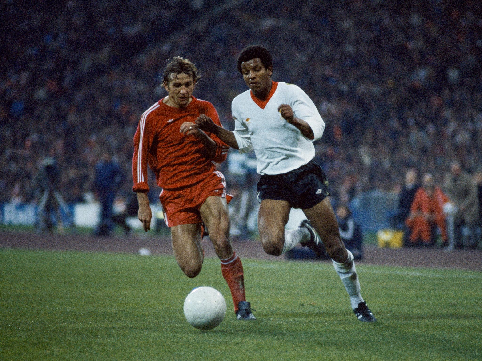 Howard Gayle storms past Wolfgang Dremmler in the second-leg of Liverpool's semi-final clash against Bayern Munich in the European Cup, April 1981 (Getty)