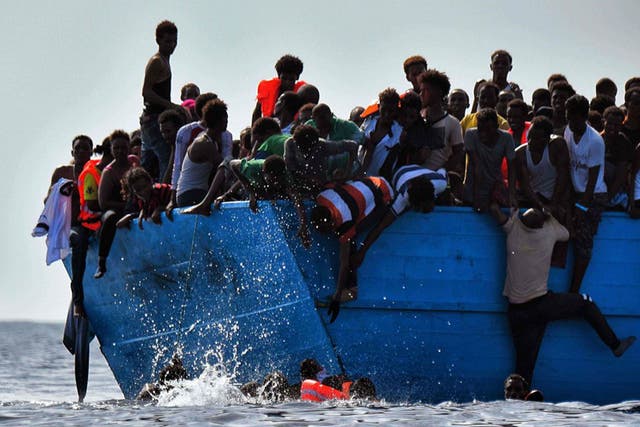 Refugees struggle not to drown as they wait to be rescued in the Mediterranean Sea, north of Libya on 4 October 2016.