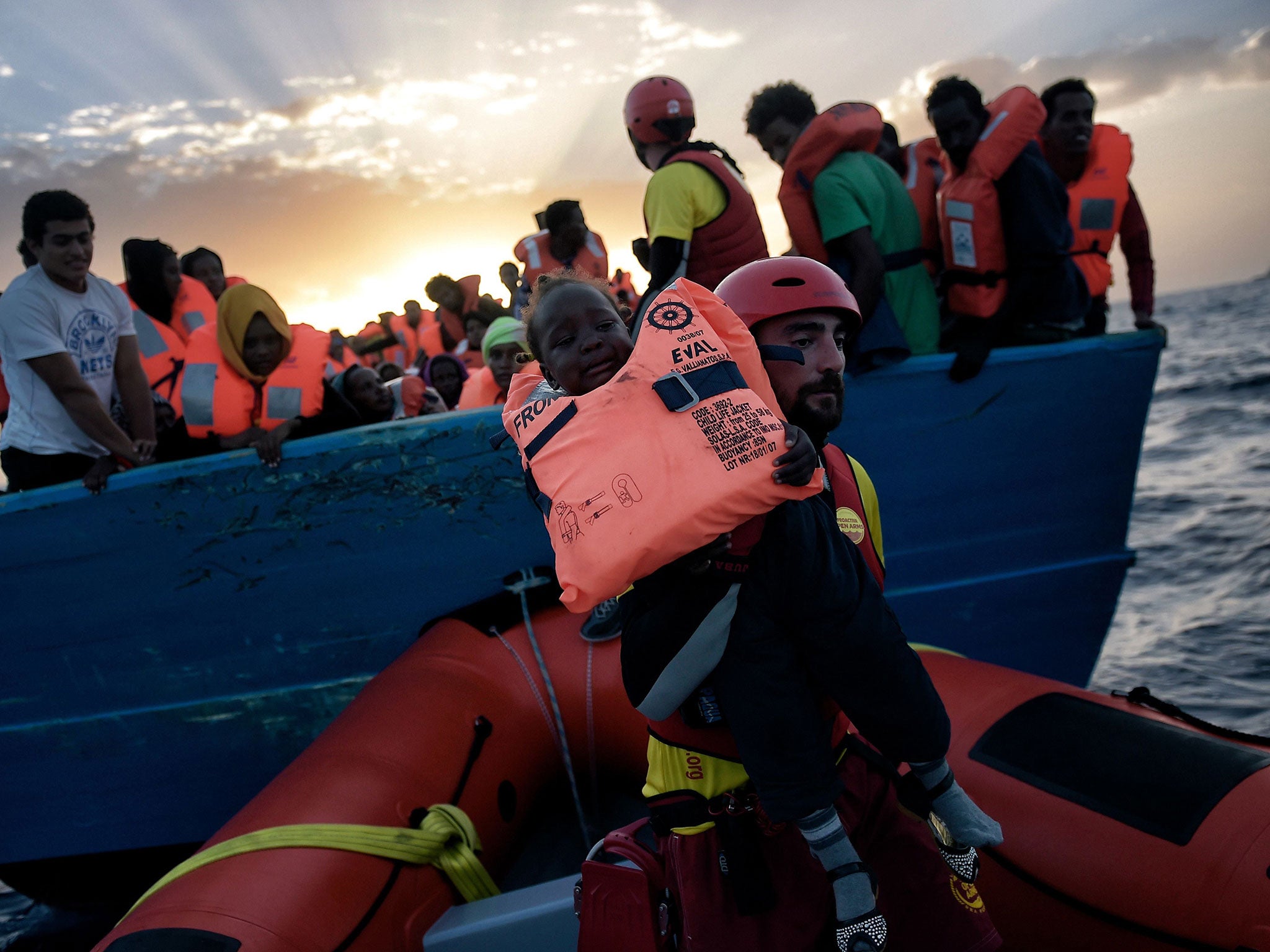 A child from African origin is rescued from a distressed vessel by a member of Proactiva Open Arms NGO 20 nautical miles north of Libya on 3 October