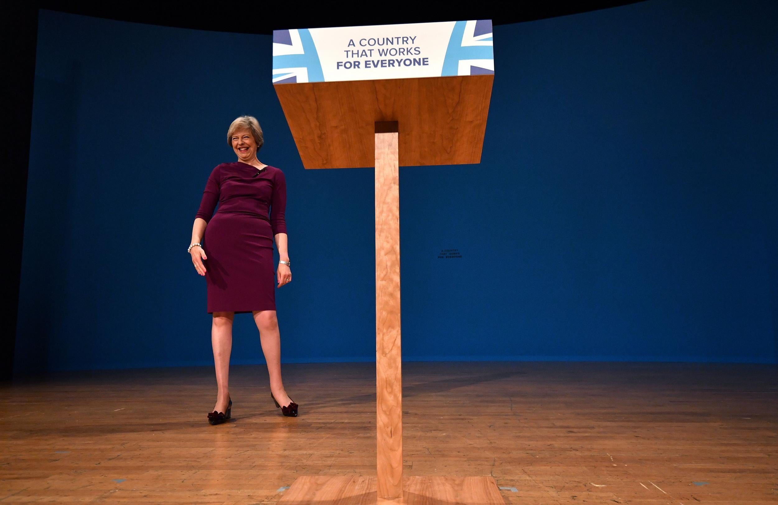 Theresa May reacts after delivering a keynote address on the final day of the annual Conservative Party conference