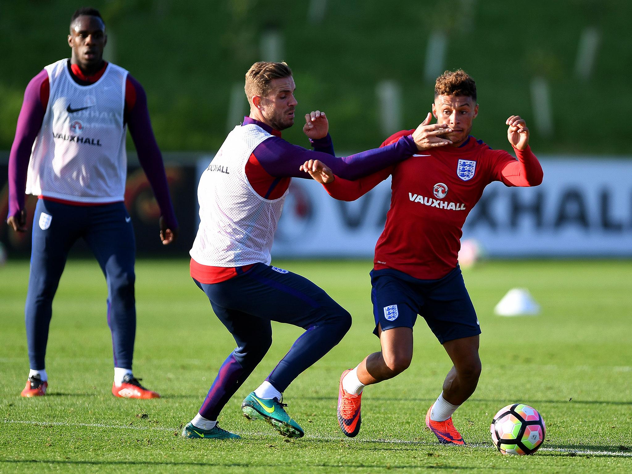 Alex Oxlade-Chamberlain (right) takes on Liverpool’s Jordan Henderson during England training at St George’s Park