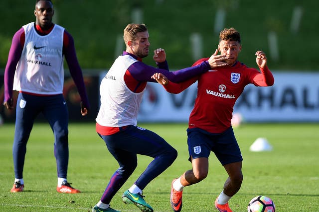 Alex Oxlade-Chamberlain (right) takes on Liverpool’s Jordan Henderson during England training at St George’s Park