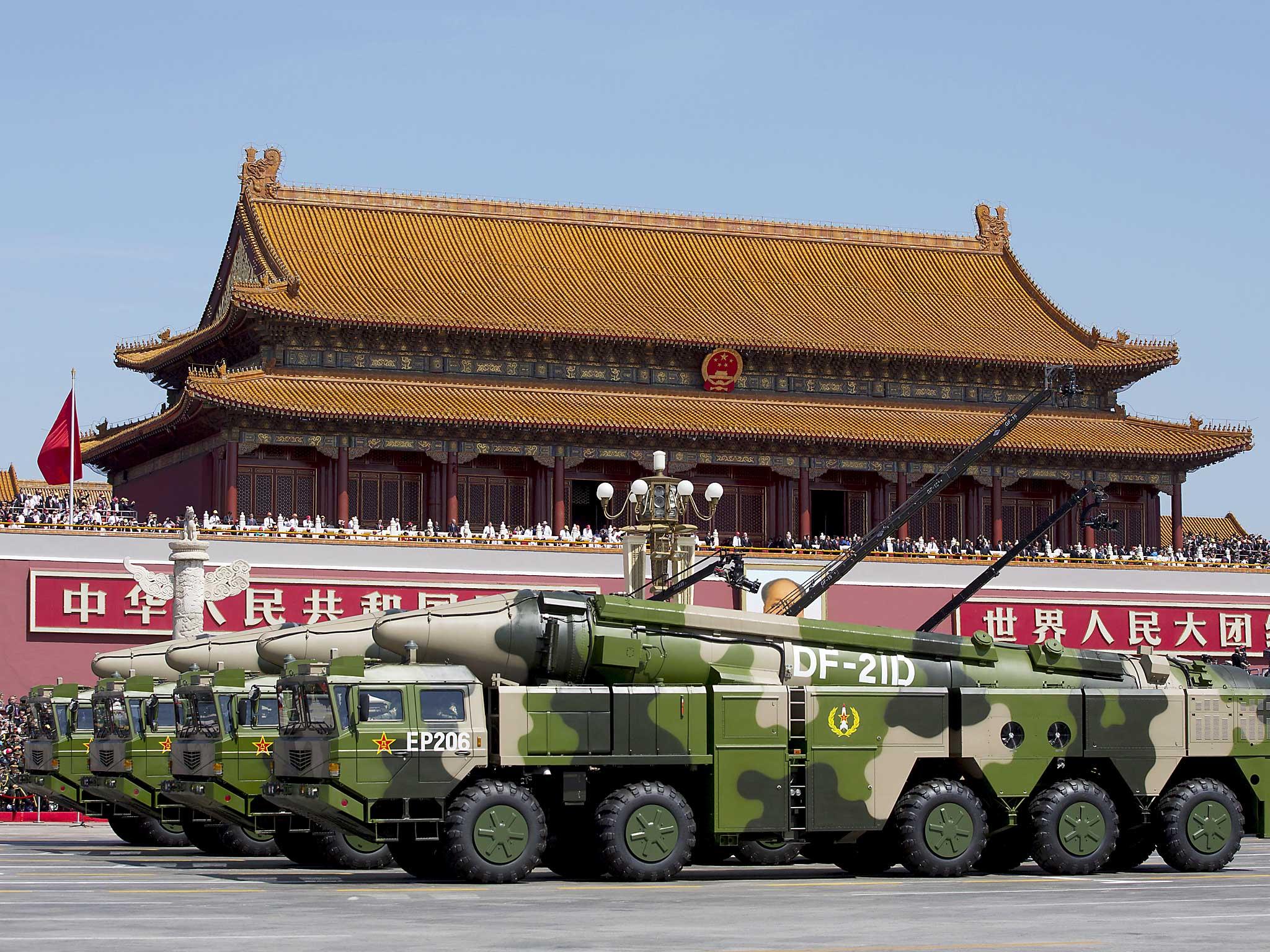 Chinese military vehicles carrying DF-21D anti-ship ballistic missiles, potentially capable of sinking a U.S. Nimitz-class aircraft carrier in a single strike, travel past Tiananmen Gate during a military parade to commemorate the 70th anniversary of the end of World War II in Beijing