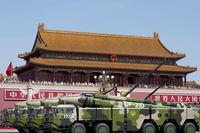 Chinese military vehicles carrying DF-21D anti-ship ballistic missiles, potentially capable of sinking a U.S. Nimitz-class aircraft carrier in a single strike, travel past Tiananmen Gate during a military parade to commemorate the 70th anniversary of the end of World War II in Beijing