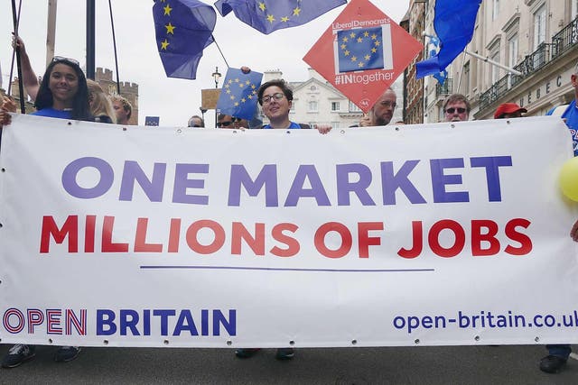 Demonstrators on the anti-Brexit March for Europe hold EU flags as they march to Parliament Square in central London