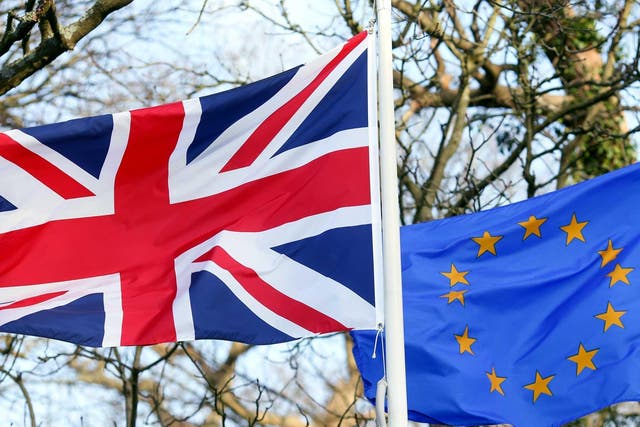 A British Union flag, commonly known as a Union Jack, left, flies next to a European Union (EU) flag