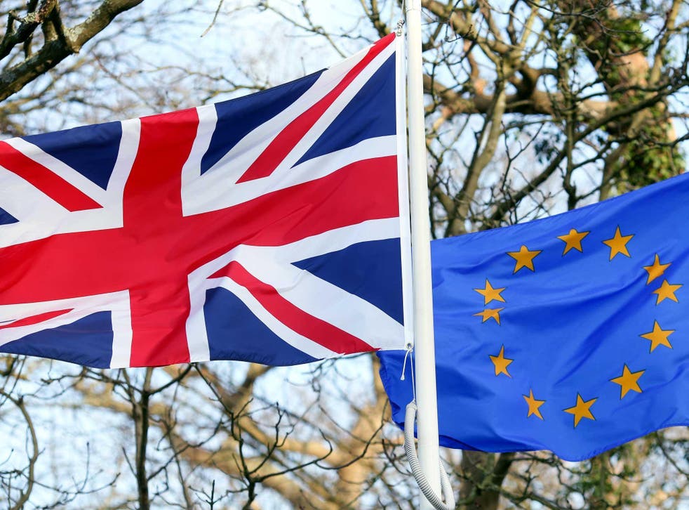A British Union flag, commonly known as a Union Jack, left, flies next to a European Union (EU) flag