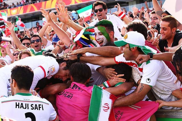 Sardar Azmoun of Iran celebrates with team mates and fans after scoring a goal during the 2015 Asian Cup match between Iran and Iraq at Canberra Stadium on January 23, 2015 in Canberra, Australia