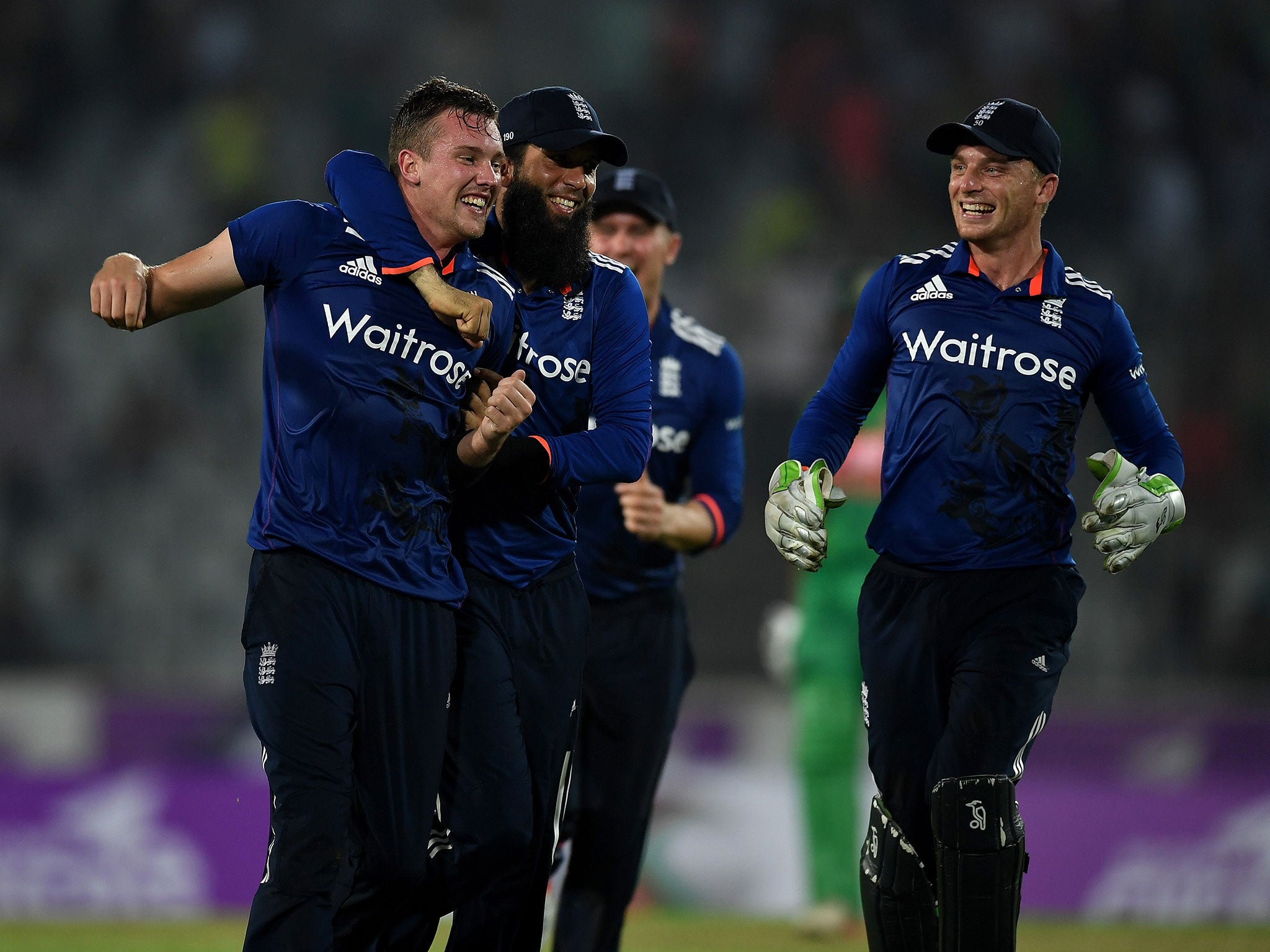 Jake Ball of England celebrates with Moeen Ali and captain Jos Buttler after taking the final wicket of Taskin Ahmed of Bangladesh to win the 1st One Day International