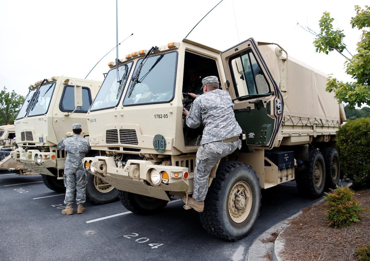 National Guard units 1782 and 172 of Chester and Lancaster, South Carolina, board vehicles while deploying for duty for Hurricane Matthew service in Conway, South Carolina, U.S. October 6, 2016. REUTERS/Randall Hill - RTSR201