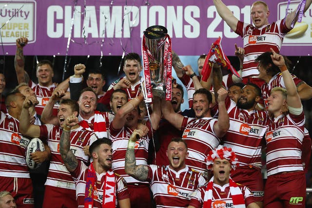 Sean O'Loughlin and Matty Smith lift the Super League trophy after Wigan's 12-6 win over Warrington