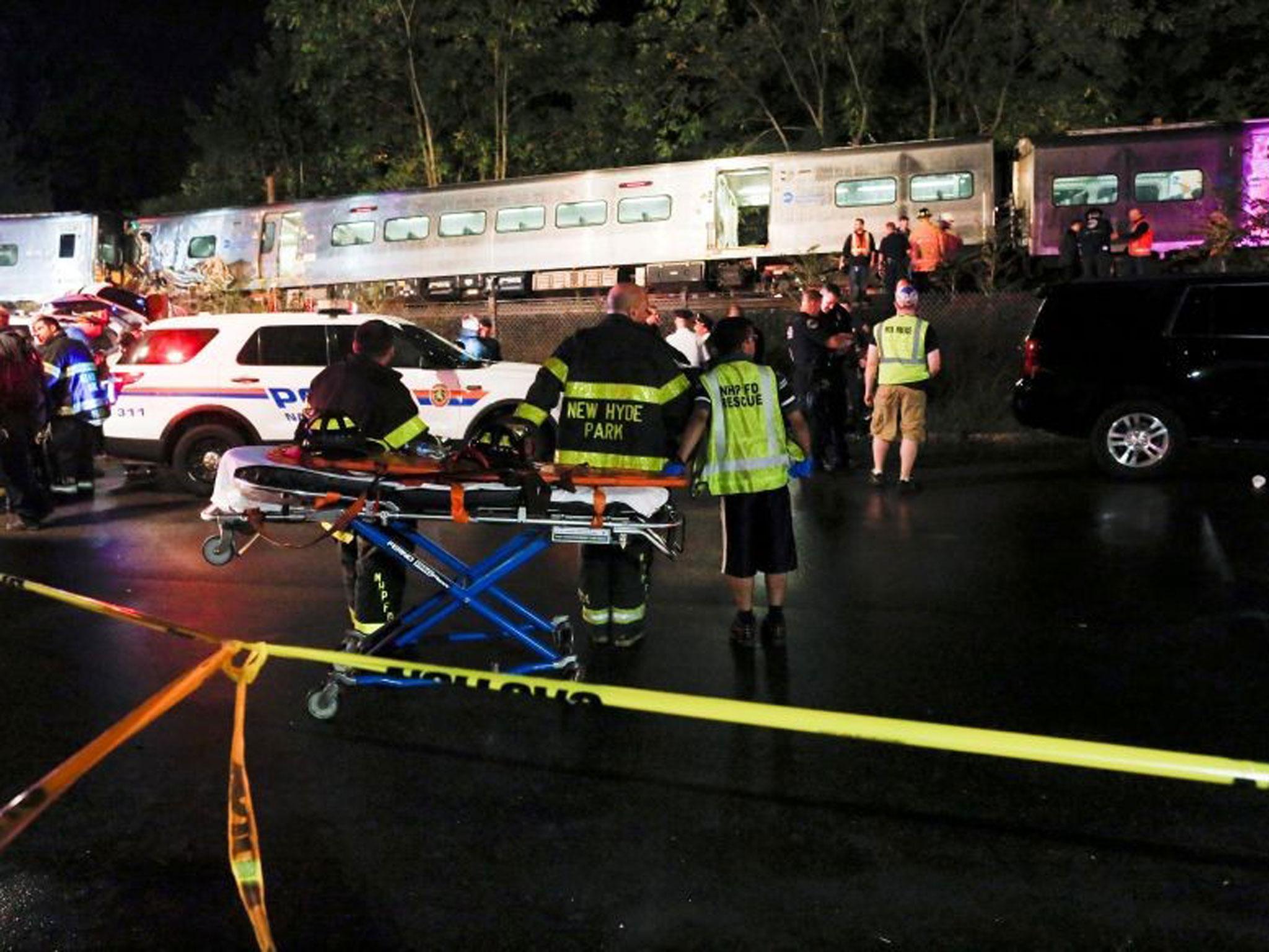 Emergency responders attend to a call of a train derailed near the community of New Hyde Park on Long Island in New York