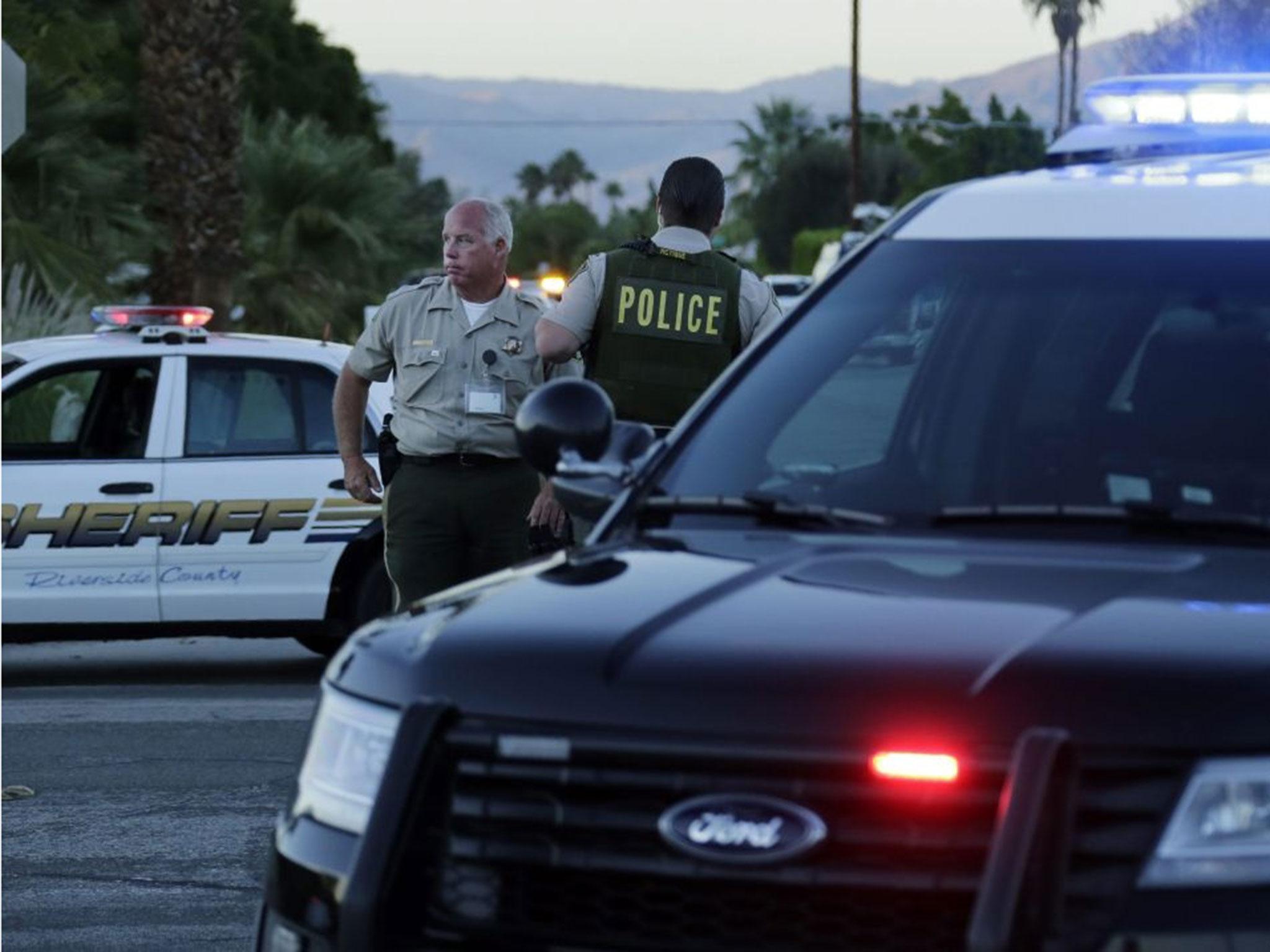 Law enforcement officers secure the perimeter near the location where two Palm Springs Police Department officers were killed and another wounded during a domestic disturbance call in Palm Springs, California, USA 08 October 2016