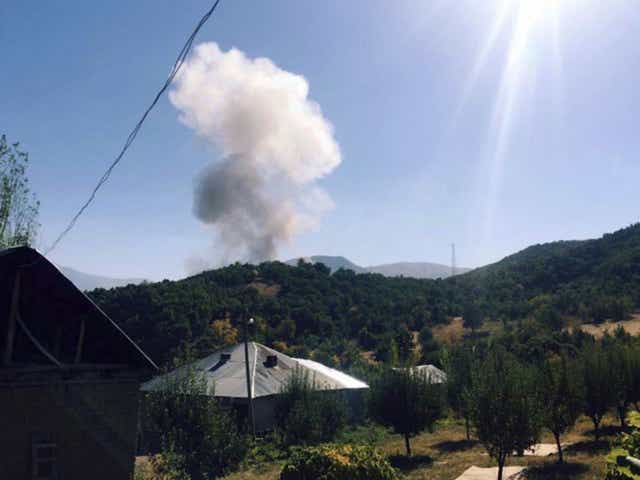 Smoke rises after Kurdish militants detonated a car bomb outside a a military station in Semdinli in Hakkari province near the border with Iraq.