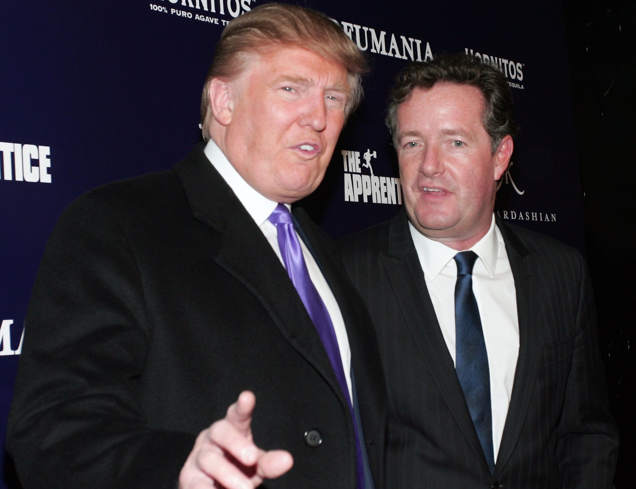 Donald Trump (L) and Piers Morgan celebrate Kim Kardashian's appearance on 'The Apprentice' at Provacateur in New York on November 10, 2010