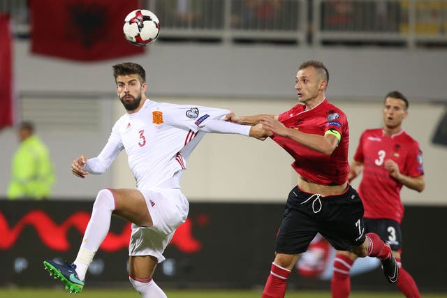 Gerard Pique clashes with Albania's Ansi Agolli during Sunday's match