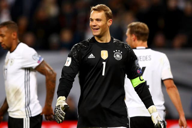 Manuel Neuer laughs to himself after managing to kick the ball into his own face