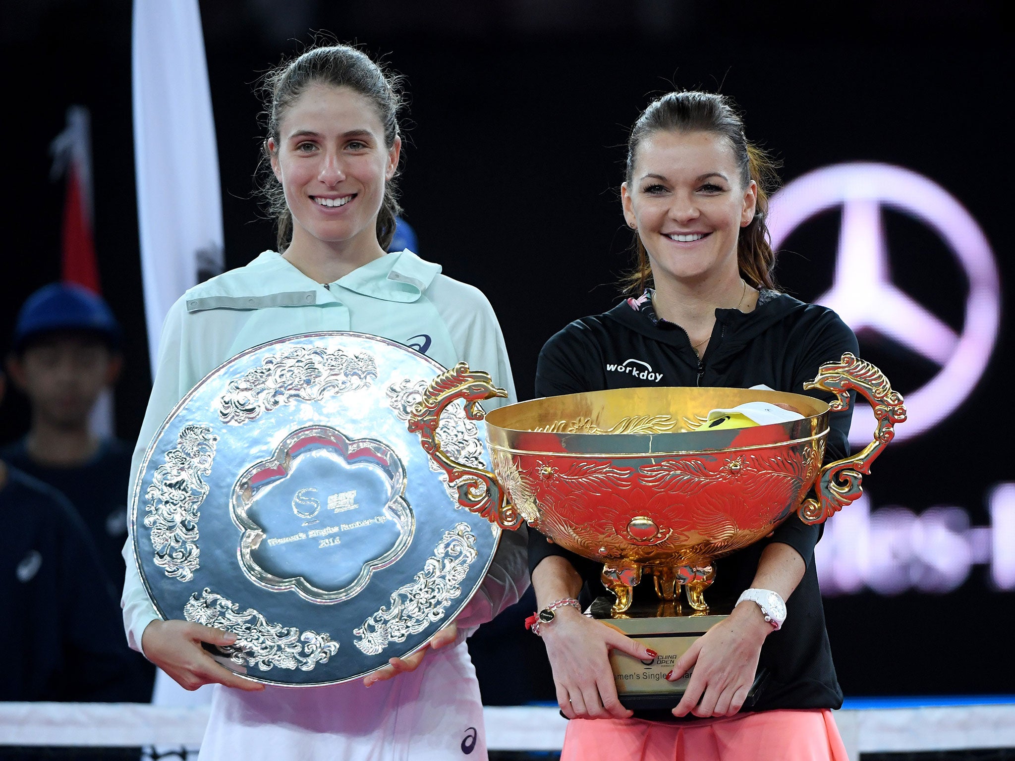 Agnieszka Radwanska of Poland and Johanna Konta of Britain together during the awards ceremony after the women's singles final of the China Open tennis tournament in Beijing.