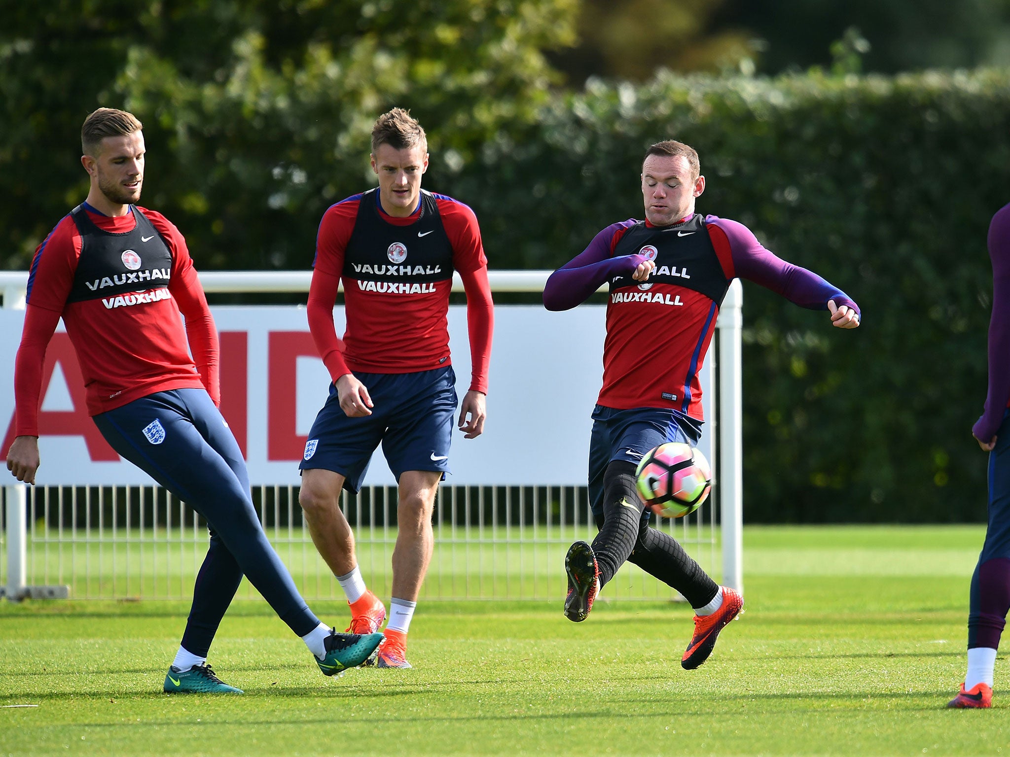 Wayne Rooney attempts to cut out Jordan Henderson's pass in training